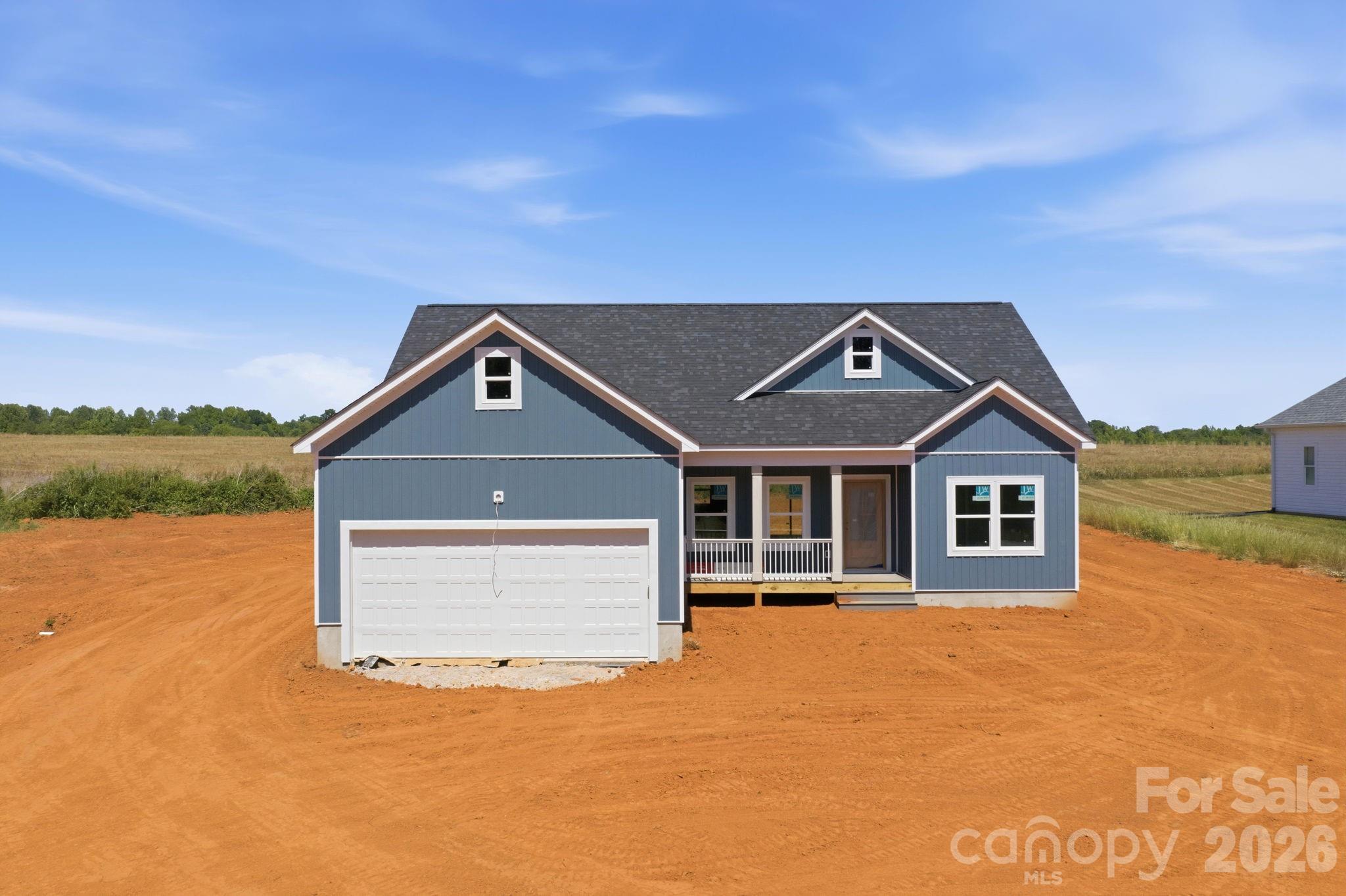 1720 Jennings Road Olin, NC 28660 - Photo 5 of 15 a front view of a house with a yard and lake view