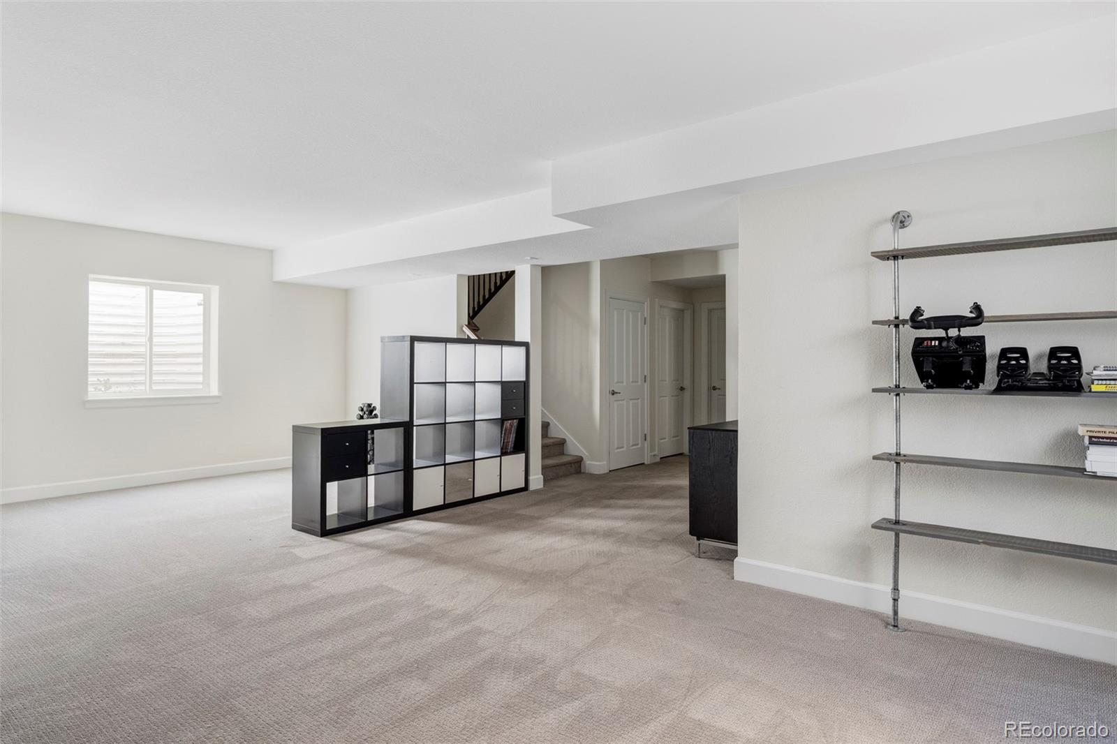 2908 Ironton Street Denver, CO 80238 - Photo 21 of 30 a spacious bedroom with a bed and a cabinets