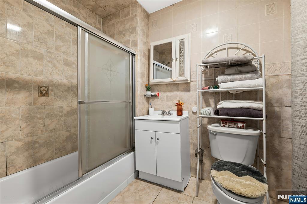 436 Ellison Street Paterson, NJ 07501 - Photo 13 of 47 a kitchen with a cabinets and appliances