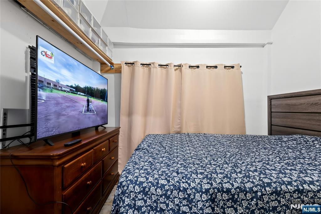 436 Ellison Street Paterson, NJ 07501 - Photo 15 of 47 a bedroom with a bed and a flat screen tv