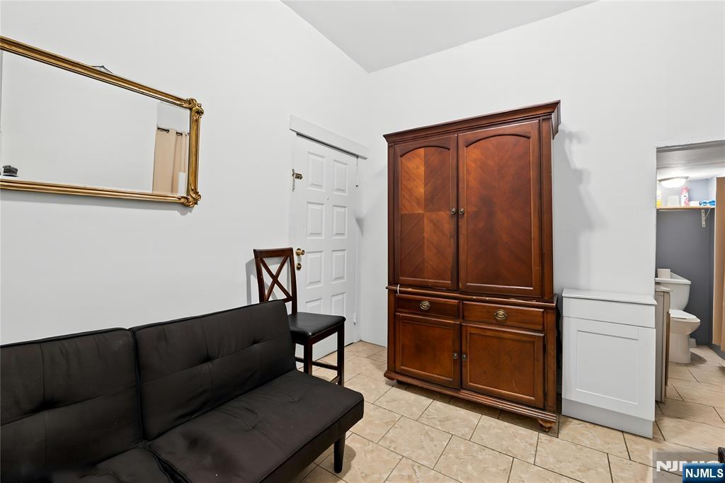 436 Ellison Street Paterson, NJ 07501 - Photo 16 of 47 a view of a livingroom with furniture and a hallway