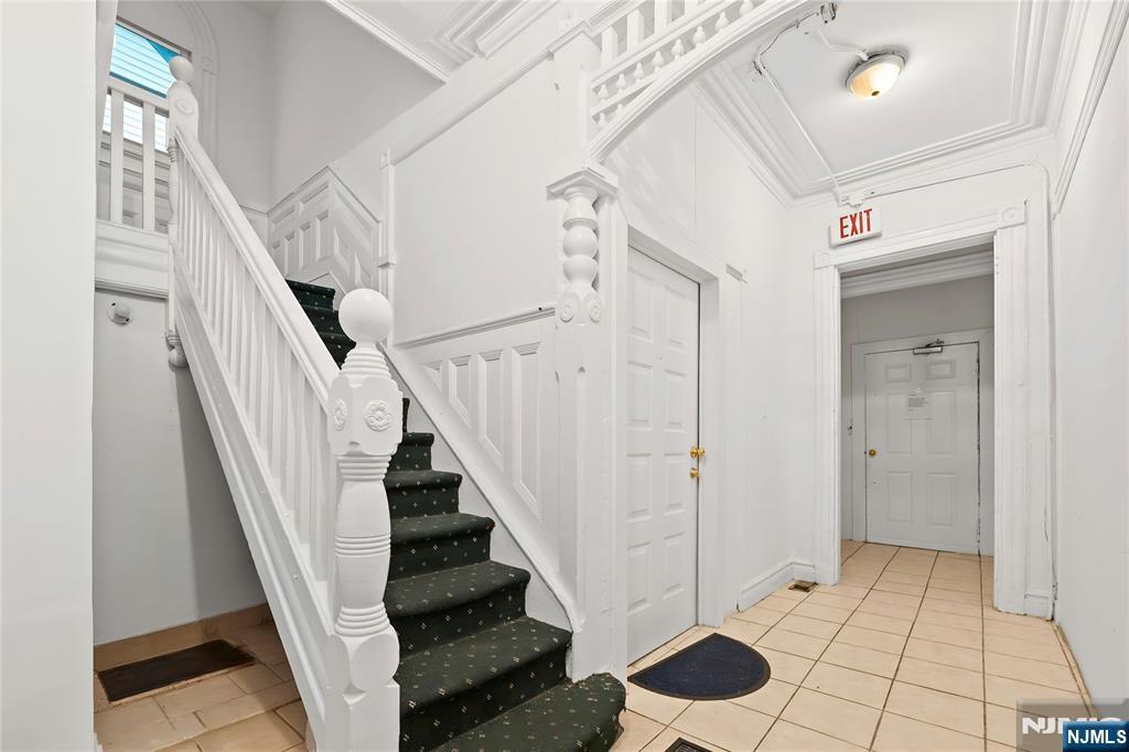 436 Ellison Street Paterson, NJ 07501 - Photo 18 of 47 a view of entryway with stairs and wooden floor