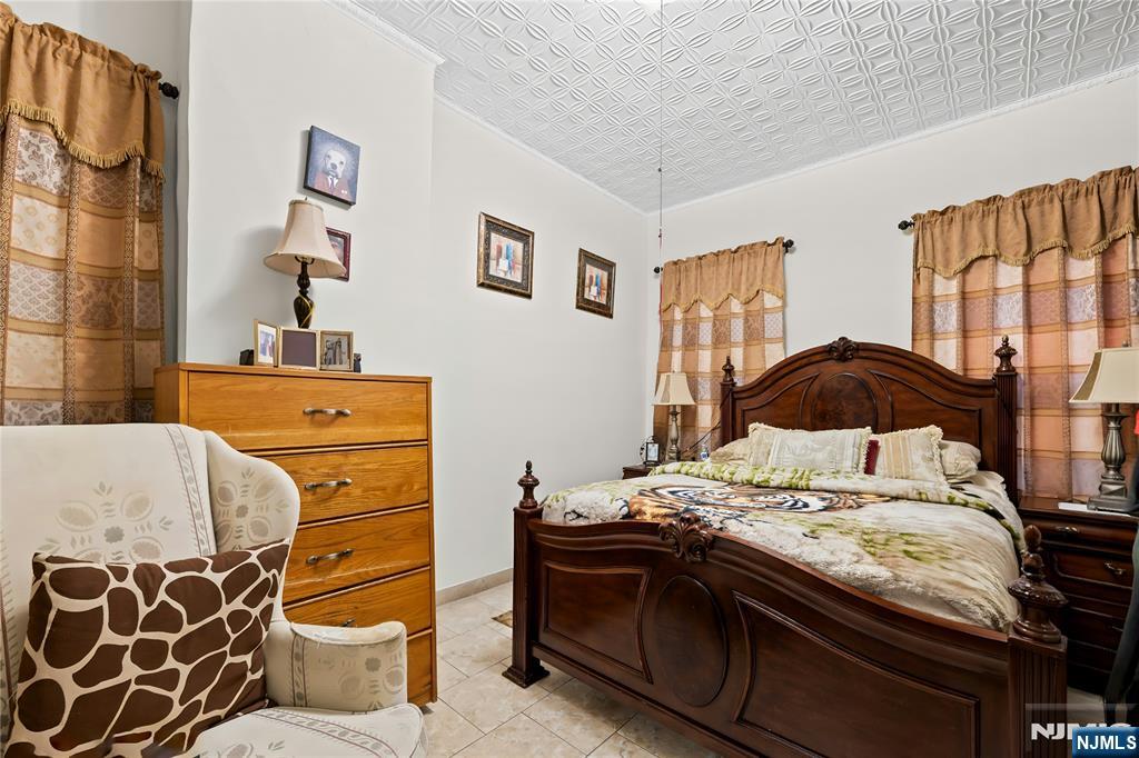 436 Ellison Street Paterson, NJ 07501 - Photo 21 of 47 a bedroom with a bed and a cabinets