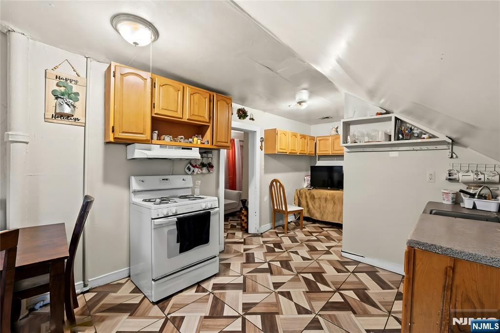 436 Ellison Street Paterson, NJ 07501 - Photo 30 of 47 a kitchen with stainless steel appliances a stove a sink and a refrigerator