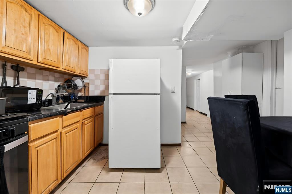 436 Ellison Street Paterson, NJ 07501 - Photo 36 of 47 a kitchen with stainless steel appliances granite countertop a refrigerator a stove top oven and a sink