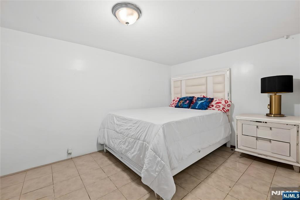 436 Ellison Street Paterson, NJ 07501 - Photo 39 of 47 a bedroom with a bed and a dresser