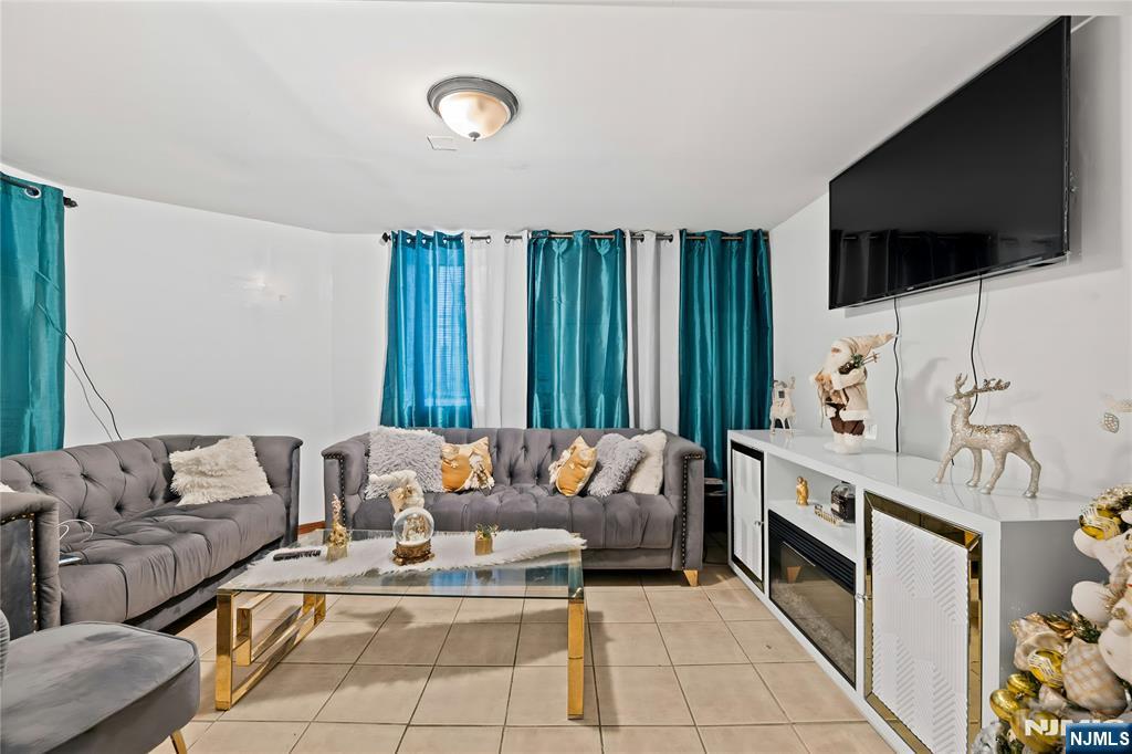 436 Ellison Street Paterson, NJ 07501 - Photo 40 of 47 a living room with furniture and a flat screen tv