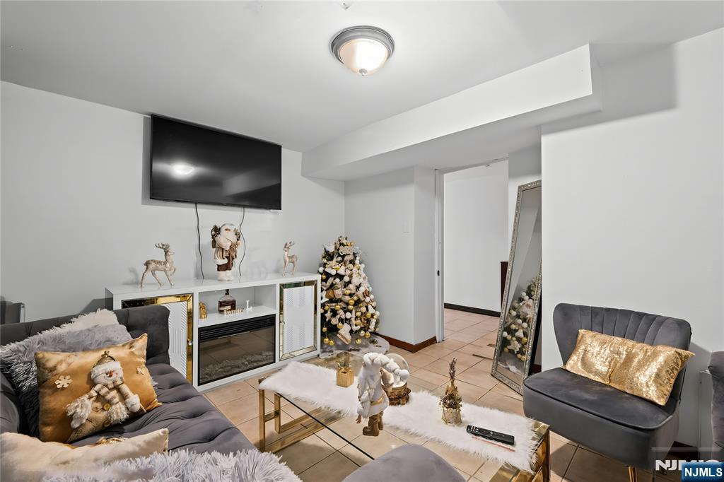 436 Ellison Street Paterson, NJ 07501 - Photo 41 of 47 a living room with furniture and a flat screen tv