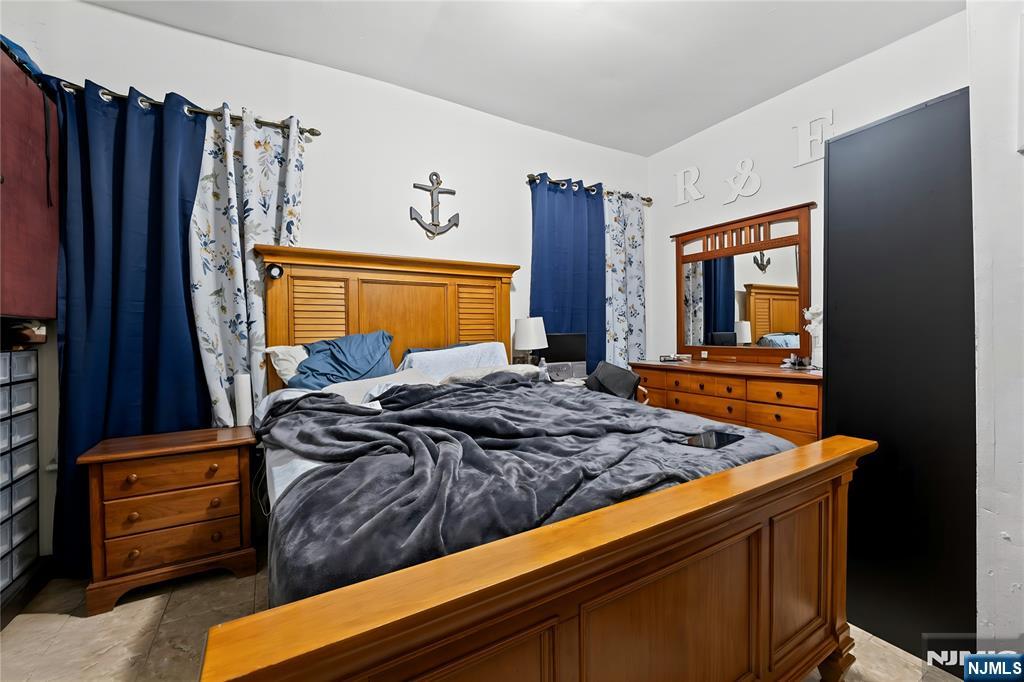 436 Ellison Street Paterson, NJ 07501 - Photo 42 of 47 a bed sitting in a bedroom next to a window