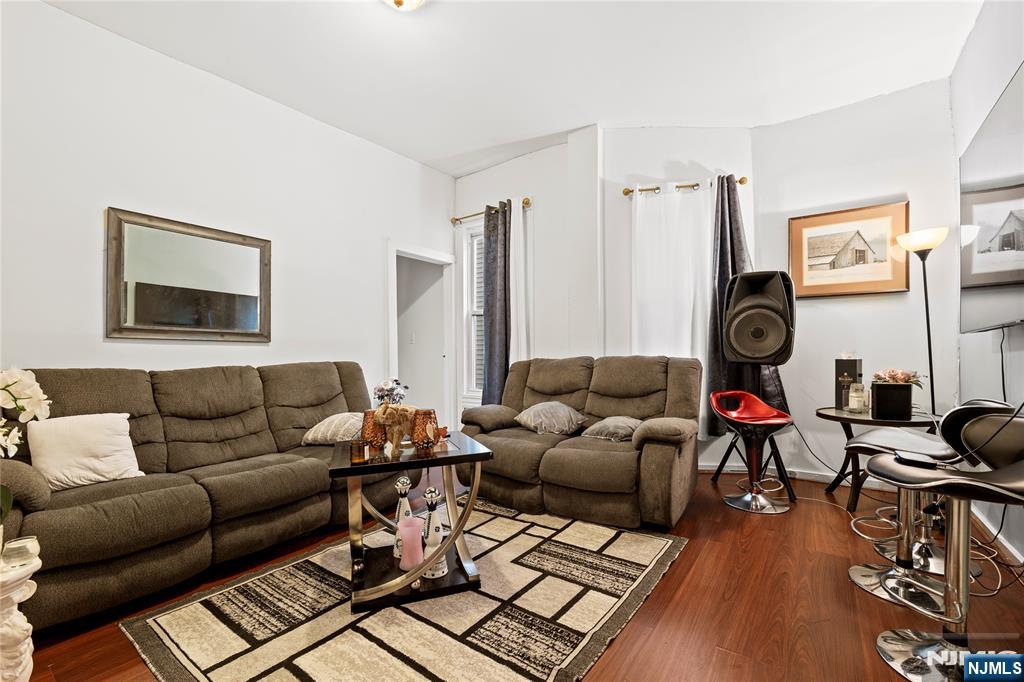 436 Ellison Street Paterson, NJ 07501 - Photo 9 of 47 a living room with furniture and a wooden floor