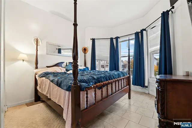 a bed sitting in a room next to a window