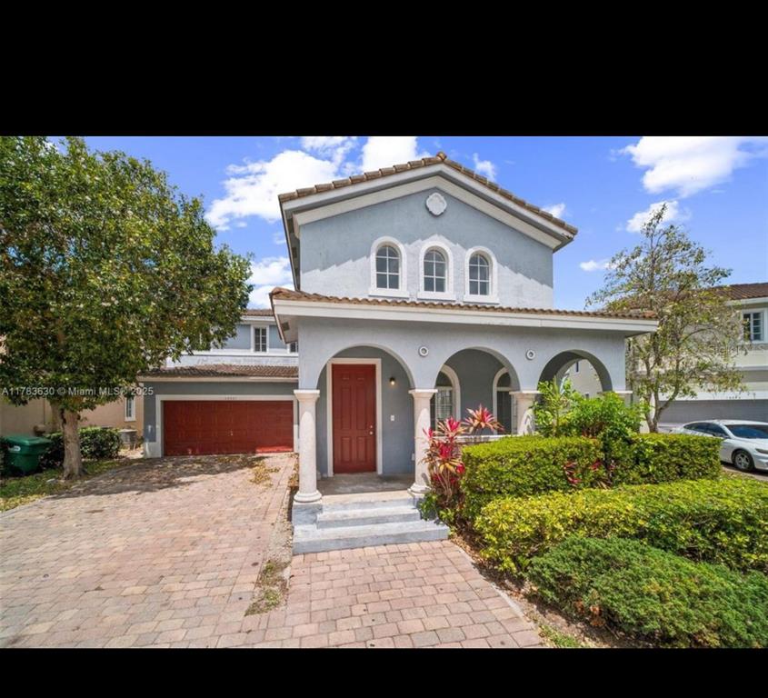 a front view of a house with garden