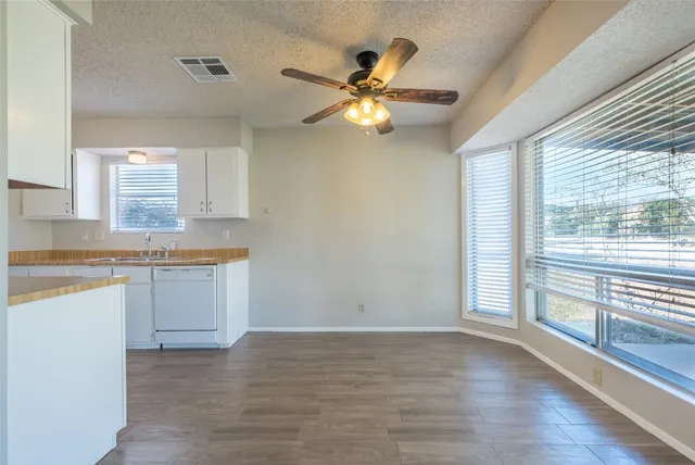 a view of a kitchen with a sink and a window