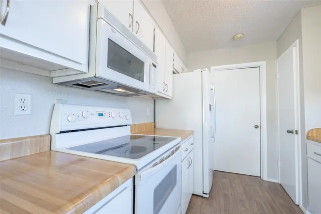a kitchen with stainless steel appliances granite countertop a sink and a microwave