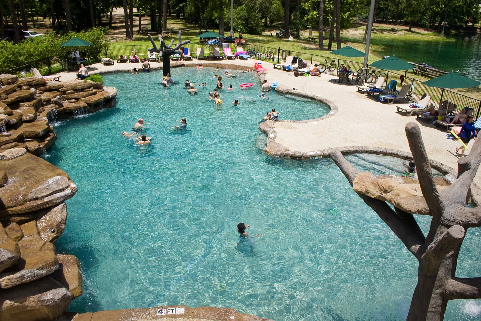61 Cedar Ridge Cleveland, TX 77327 - Photo 19 of 24 Swimming pool with hot tub, bathhouse, and sunning deck.