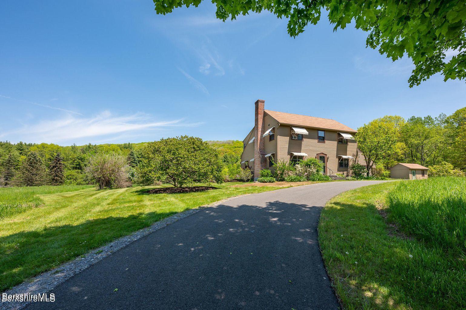 a view of a big house with a big yard and palm trees
