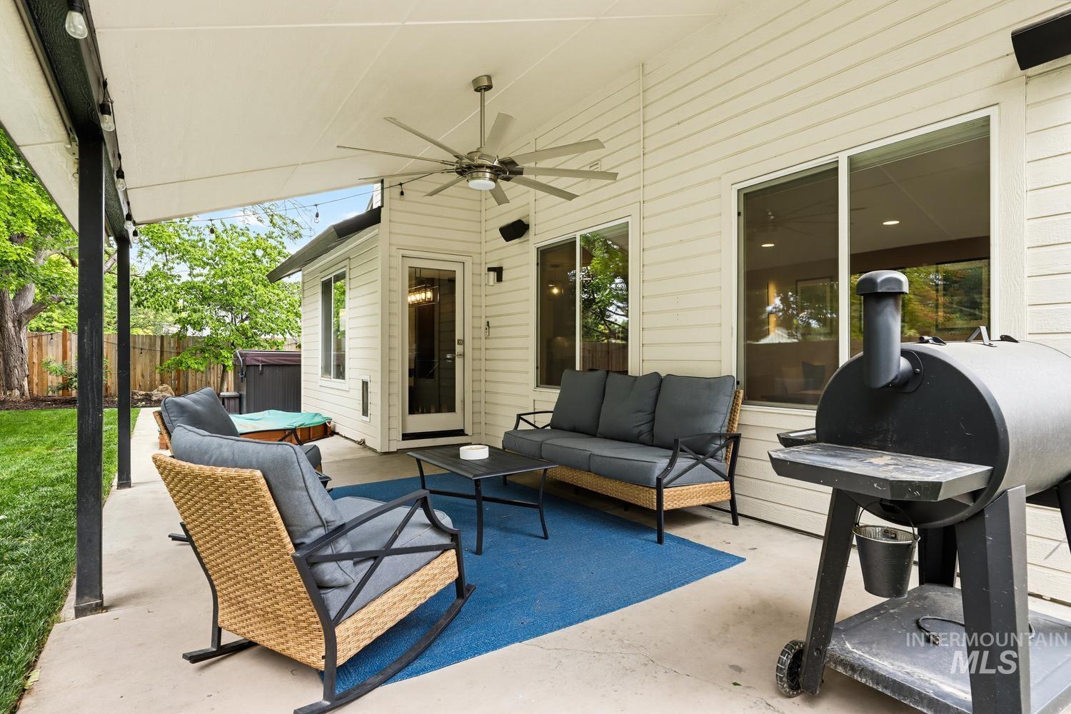 369 South Winthrop Way Boise, ID 83709 - Photo 39 of 50 Covered concrete patio featuring white siding, a built-in ceiling fan, and multiple large windows