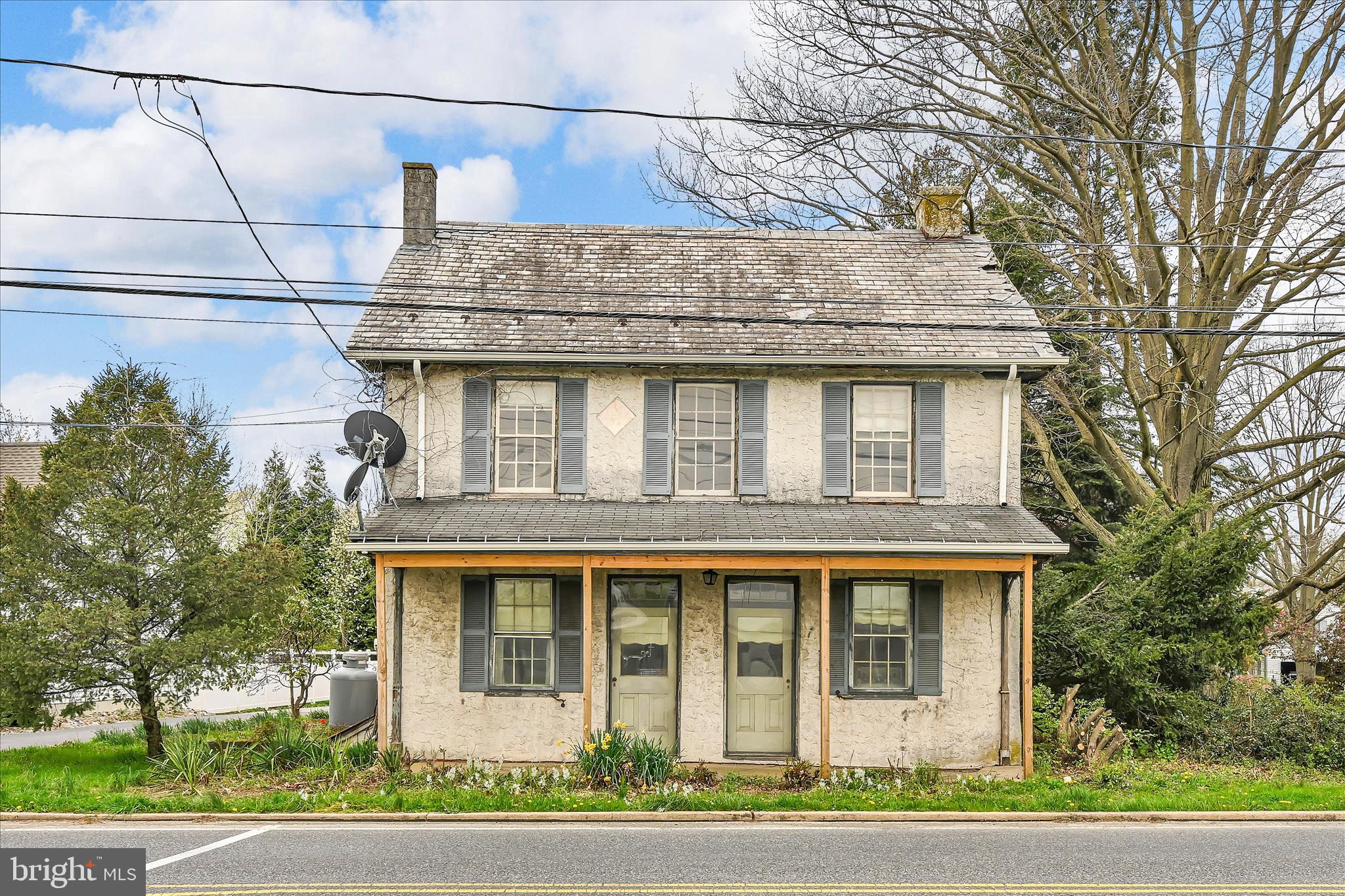 a front view of a house with a garden and plants