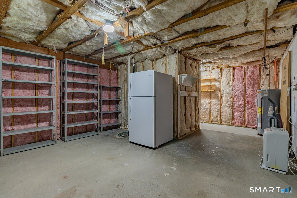 5 Thelbridge Street, Unit 5 Madison, CT 06443 - Photo 30 of 37 Unfinished basement storage with add'l refrigerator