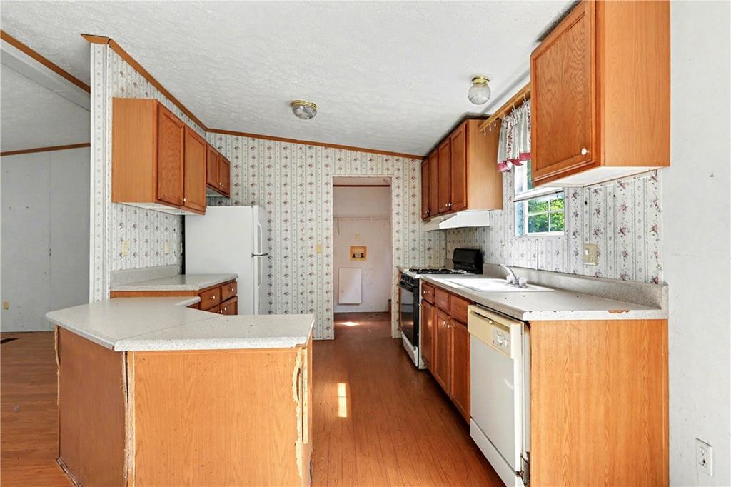 249 John Golden Road Temple, GA 30179 - Photo 19 of 45 a kitchen with stainless steel appliances granite countertop a sink stove and refrigerator