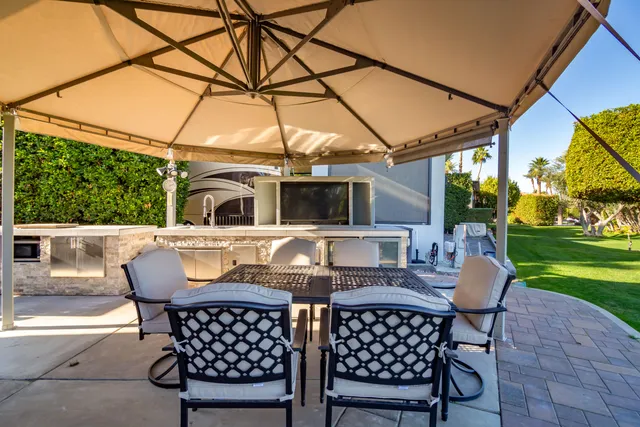 a view of a chairs and table in the garden