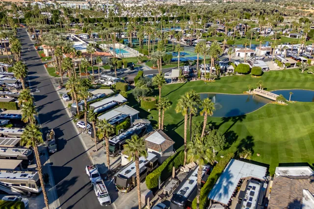 a view of a patio with chairs and umbrellas