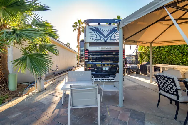a view of chairs and table in the patio