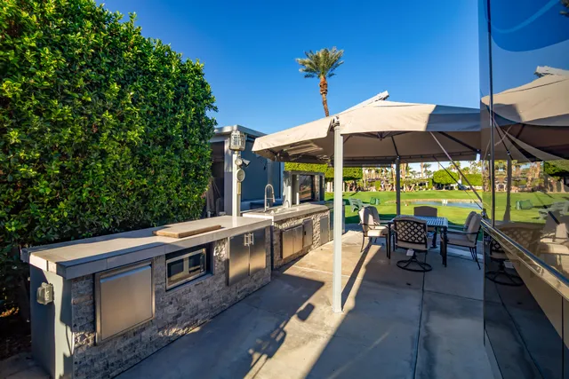 a view of a cafe with a table and chairs under an umbrella