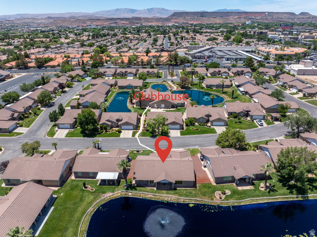 805 South River Road, Unit 70 St. George, UT 84790 - Photo 29 of 38 Community setting featuring a central pond with fountains, mature landscaping, and single-story residences with attached garages