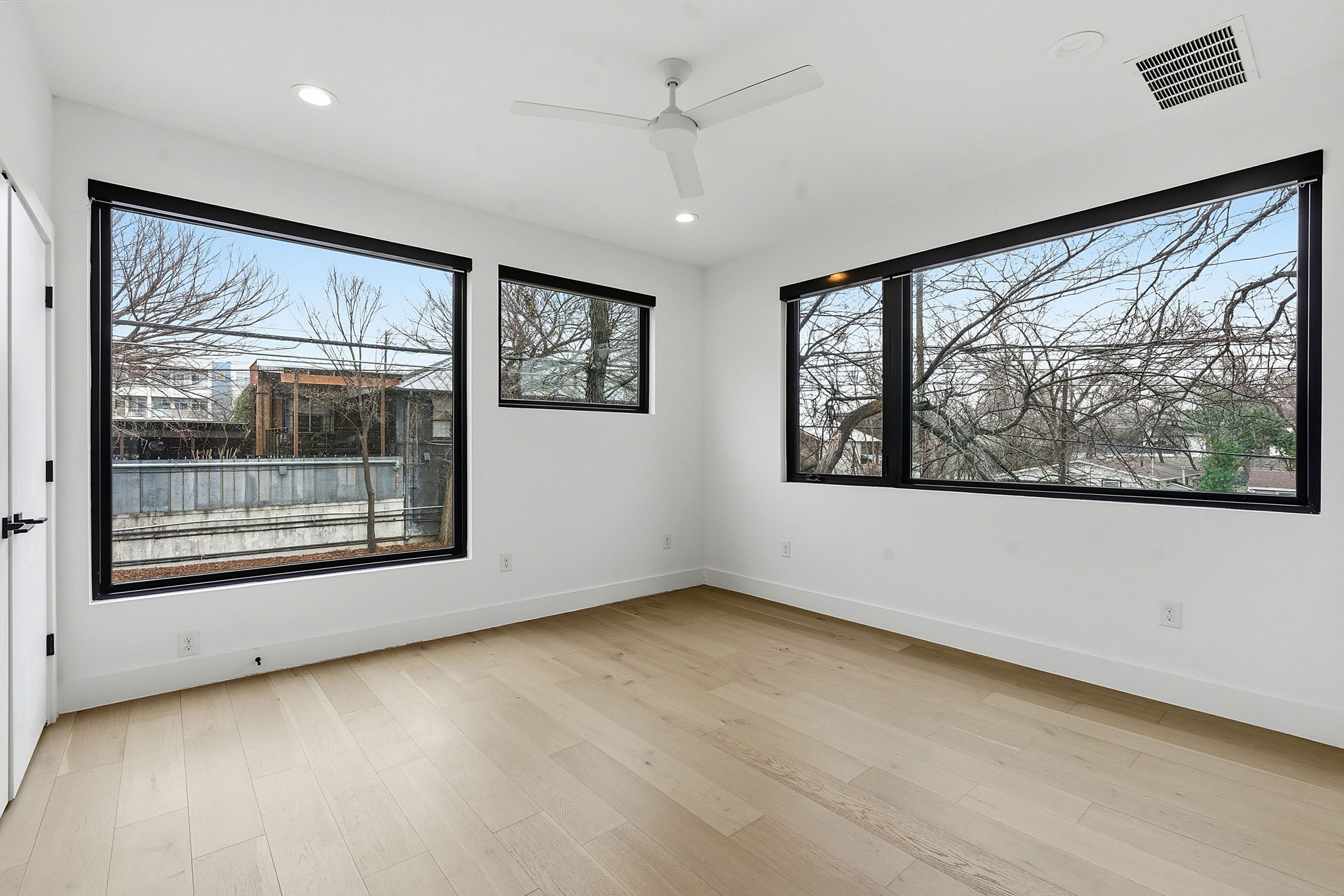 2411 Santa Rosa Street, Unit A Austin, TX 78702 - Photo 18 of 24 Unfurnished room with a ceiling fan, light wood-style flooring, and recessed lighting