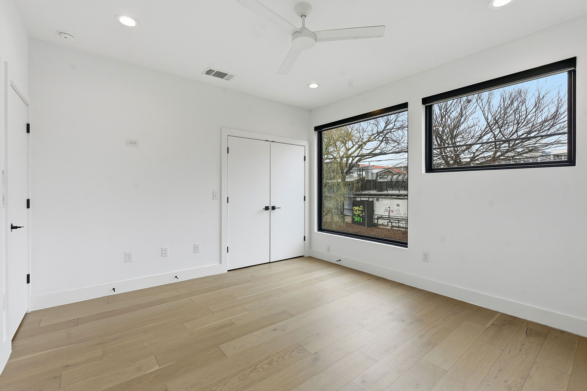 2411 Santa Rosa Street, Unit A Austin, TX 78702 - Photo 19 of 24 Unfurnished bedroom featuring light wood-style flooring, ceiling fan, recessed lighting, and a closet