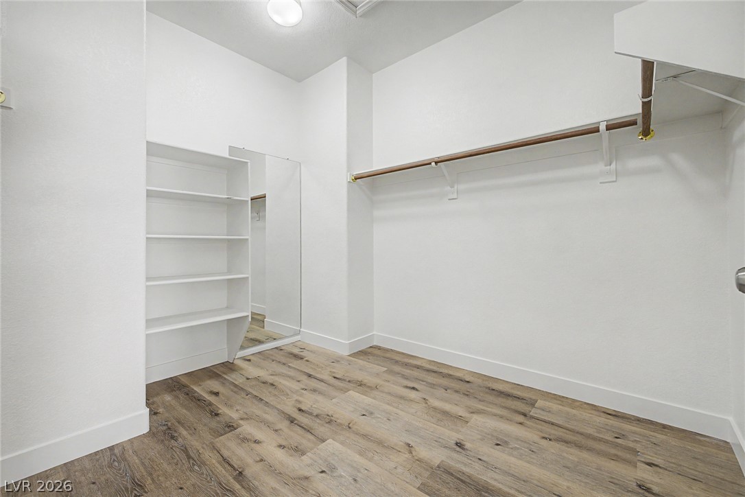 835 Entrada Ridge Avenue Henderson, NV 89012 - Photo 18 of 34 Functional custom shelving and hanging rods maximize storage in this spacious walk-in closet.