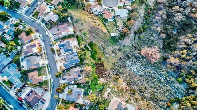 an aerial view of residential houses with outdoor space and swimming pool