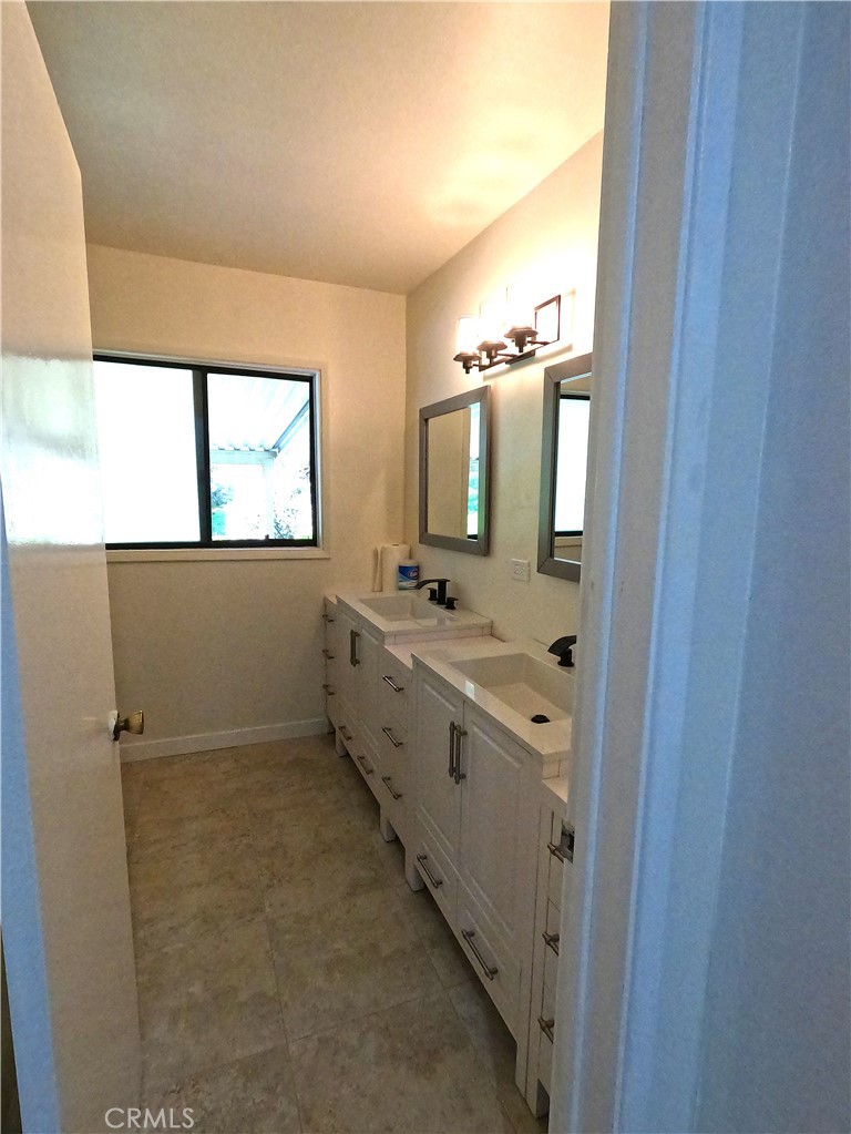 1515 Belleau Road Glendale, CA 91206 - Photo 15 of 35 a bathroom with a double vanity sink a mirror and a bathtub