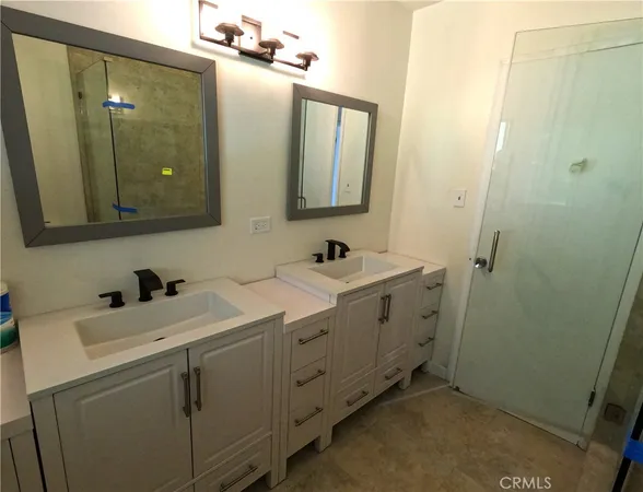 a bathroom with a double vanity sink and mirror