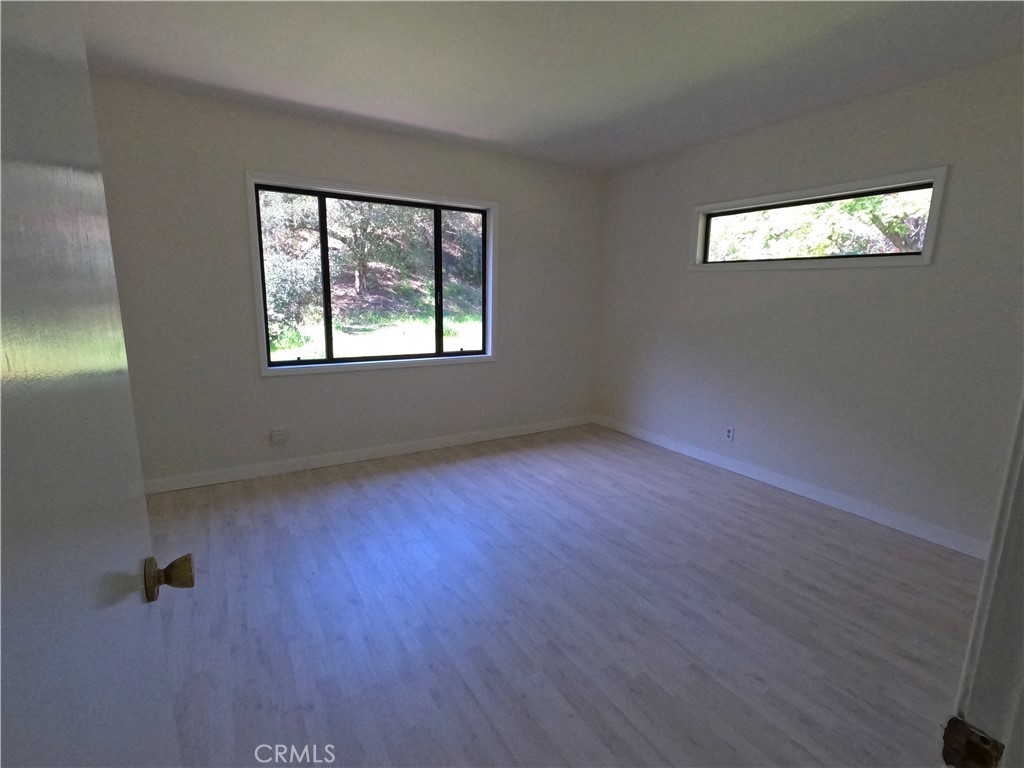 1515 Belleau Road Glendale, CA 91206 - Photo 22 of 35 a view of an empty room with wooden floor and a window