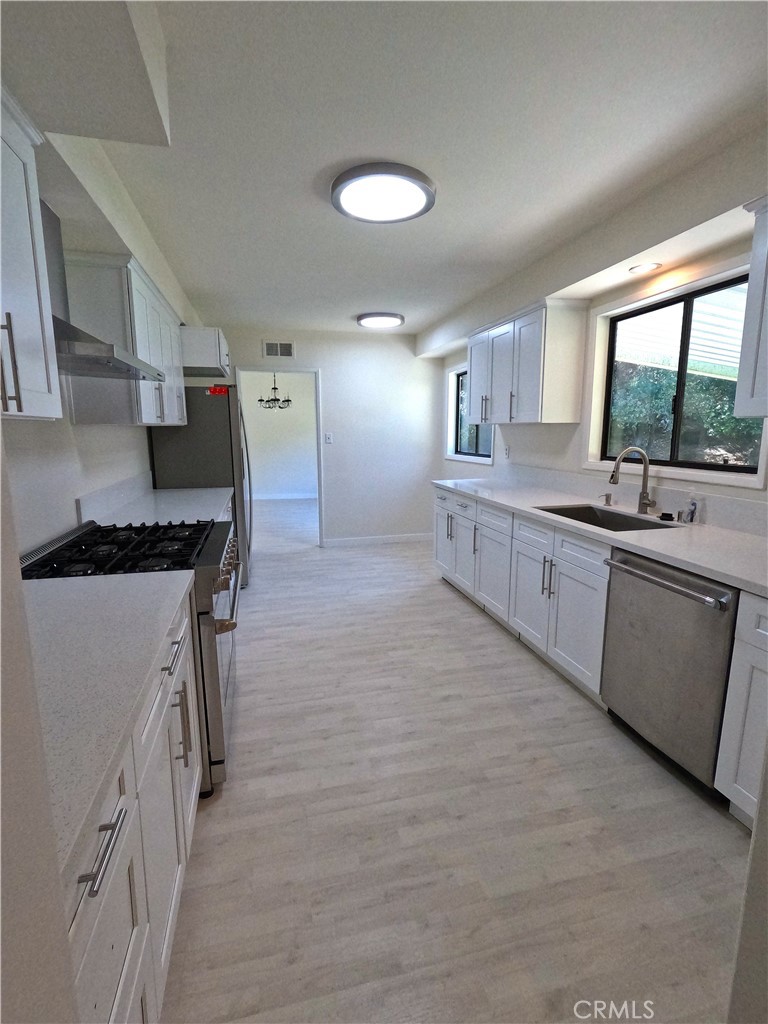 1515 Belleau Road Glendale, CA 91206 - Photo 5 of 35 a large kitchen with stainless steel appliances granite countertop a stove a sink and a refrigerator