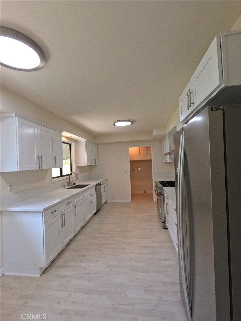 1515 Belleau Road Glendale, CA 91206 - Photo 8 of 35 a large kitchen with cabinets and stainless steel appliances