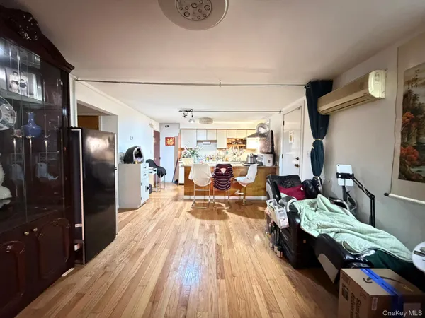 a very nice looking room with wooden floor and furniture