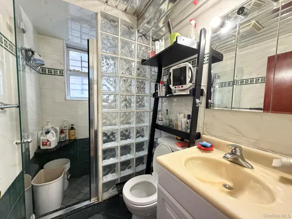 a bathroom with a sink a toilet and shower