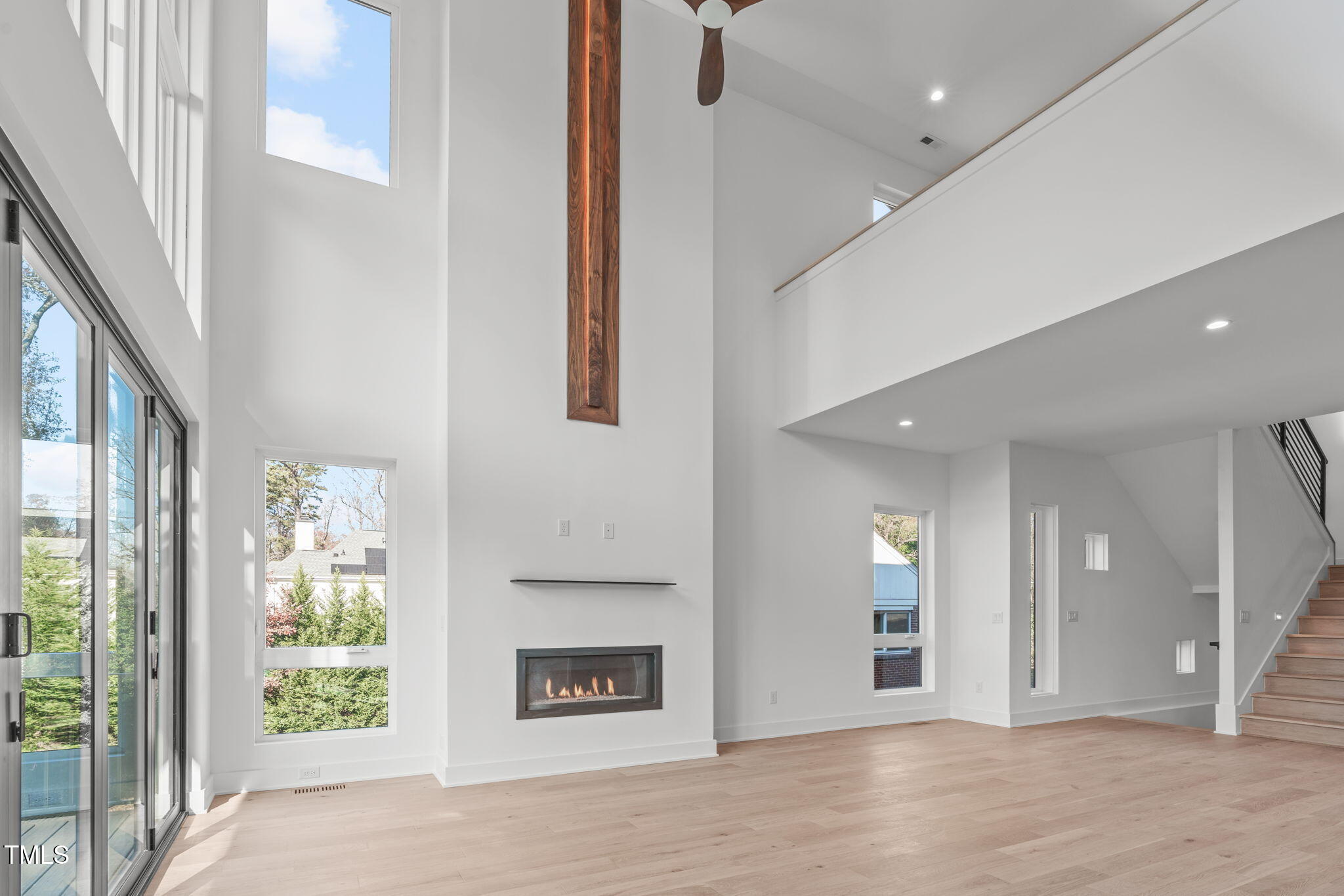 1439 Duplin Road Raleigh, NC 27607 - Photo 16 of 78 a view of a hallway with wooden floor and a fireplace
