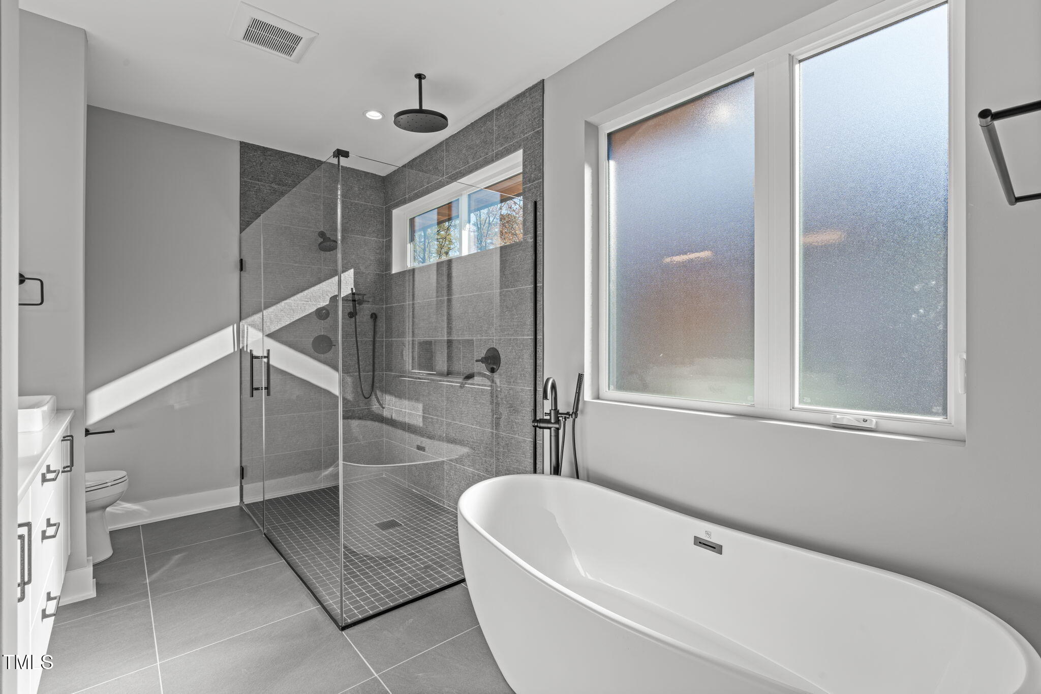 1439 Duplin Road Raleigh, NC 27607 - Photo 29 of 78 a bathroom with a bathtub and a shower