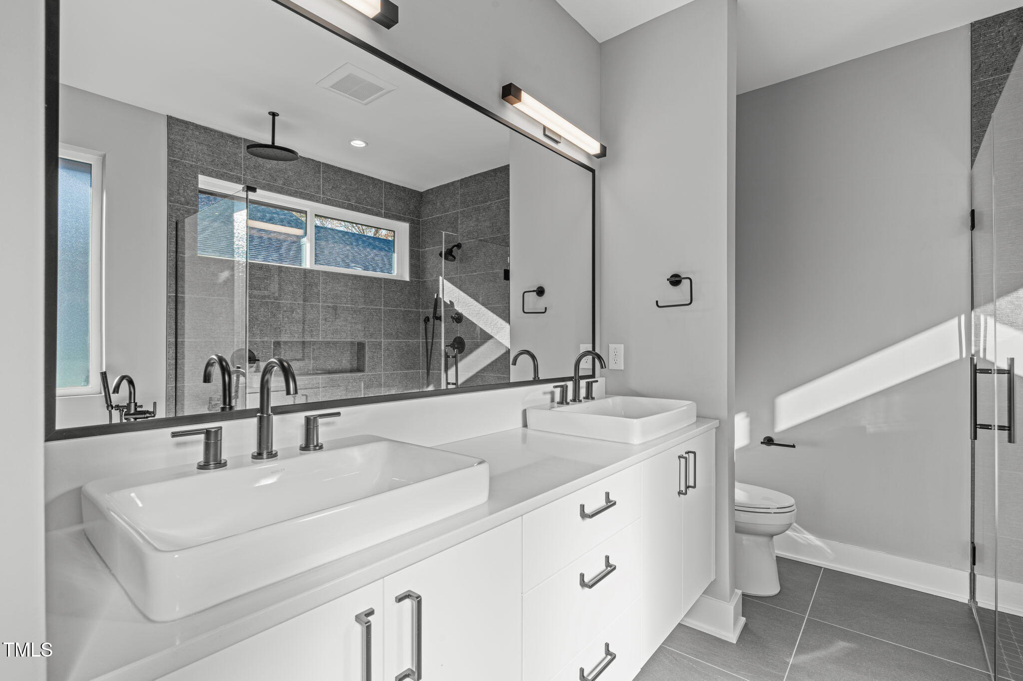 1439 Duplin Road Raleigh, NC 27607 - Photo 31 of 78 a bathroom with a sink double vanity and a toilet