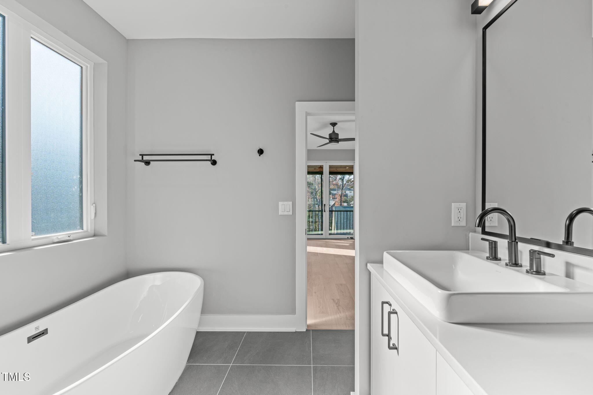 1439 Duplin Road Raleigh, NC 27607 - Photo 32 of 78 a bathroom with a tub sink and mirror