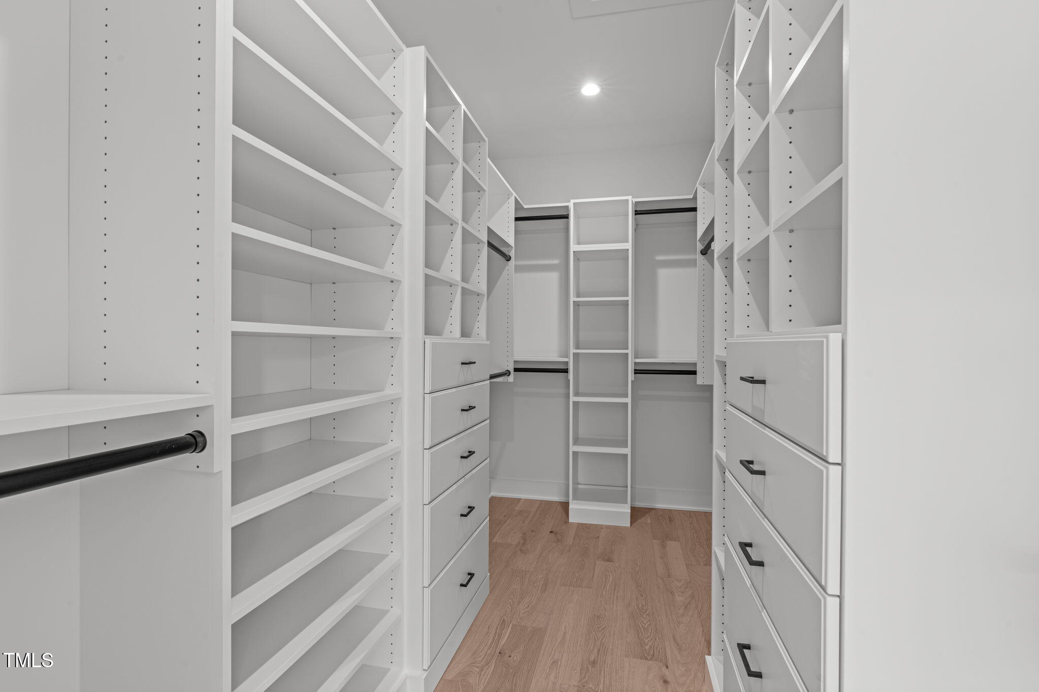 1439 Duplin Road Raleigh, NC 27607 - Photo 33 of 78 a view of walk in closet with empty racks