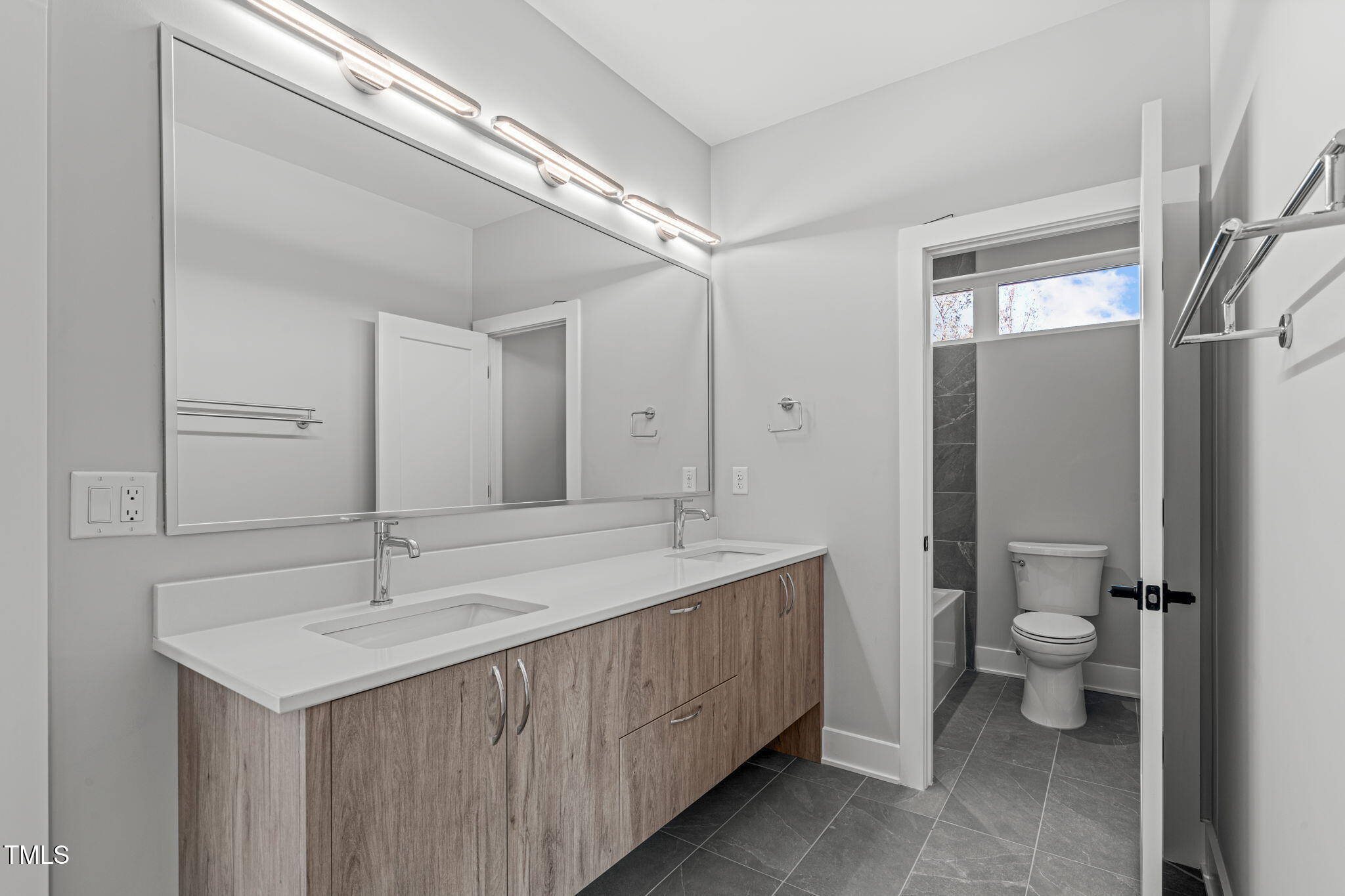 1439 Duplin Road Raleigh, NC 27607 - Photo 43 of 78 a bathroom with a sink and a mirror