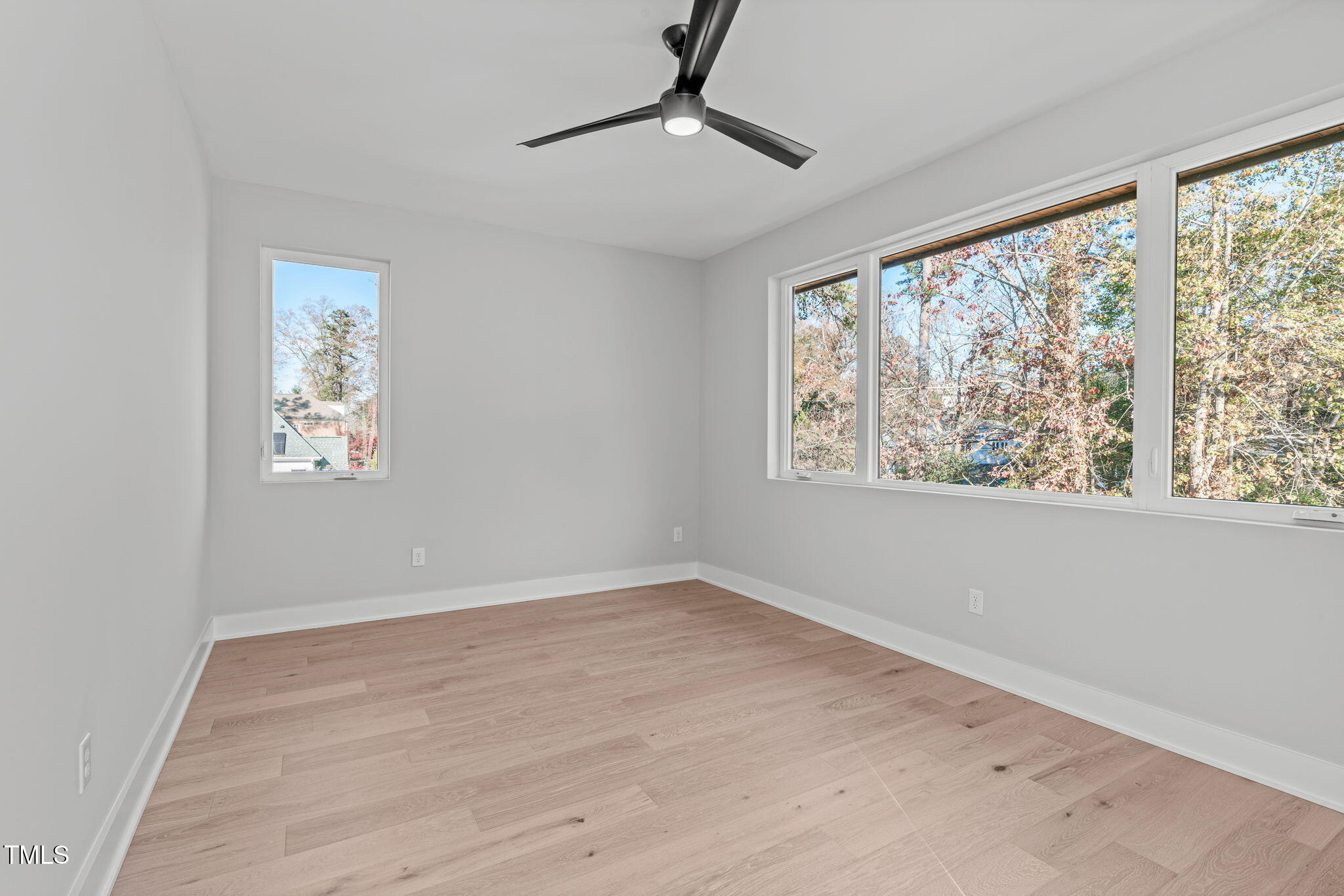 1439 Duplin Road Raleigh, NC 27607 - Photo 44 of 78 a view of an empty room with a window and a ceiling fan