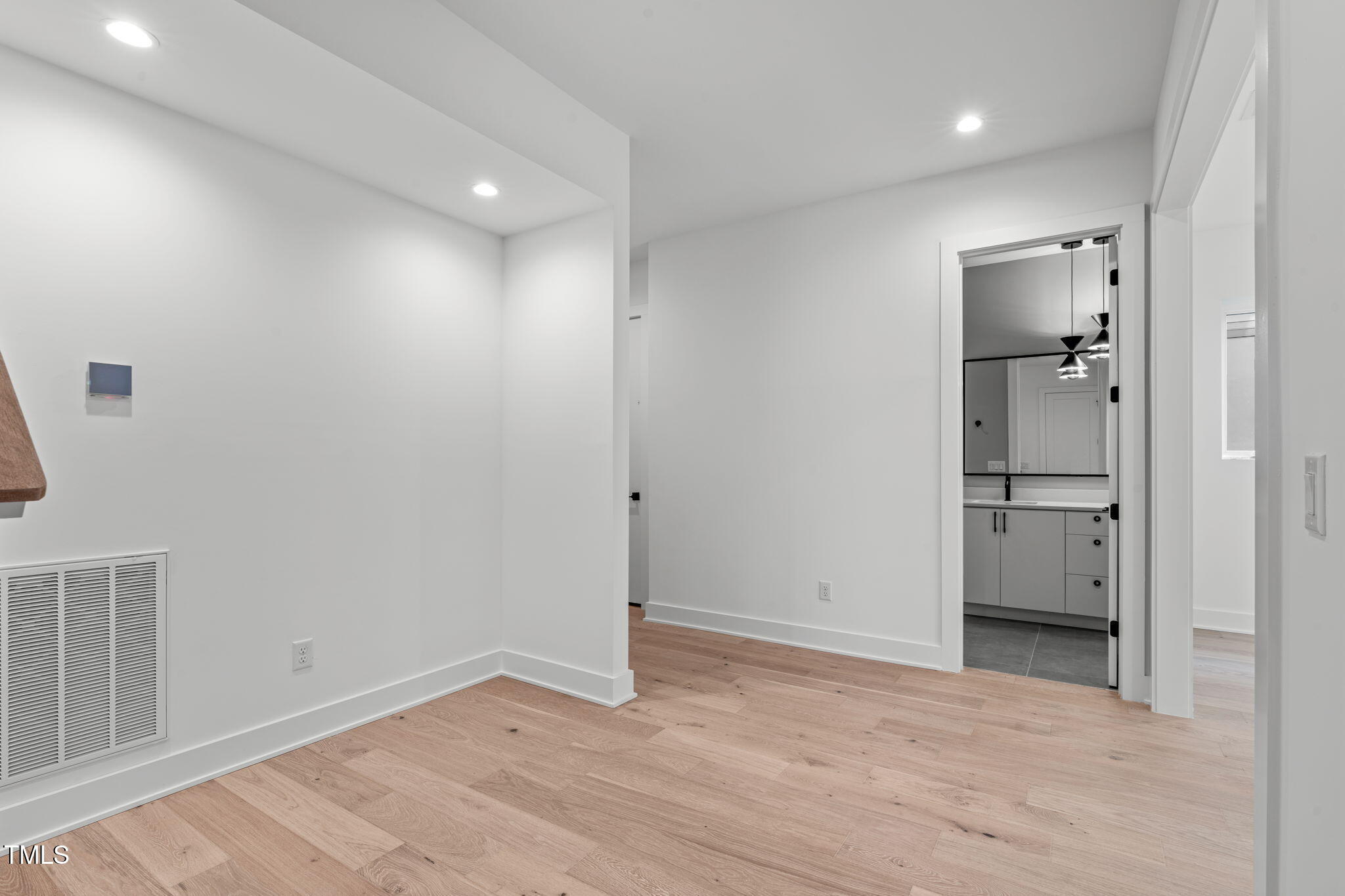 1439 Duplin Road Raleigh, NC 27607 - Photo 47 of 78 wooden floor in an empty room with a bathroom