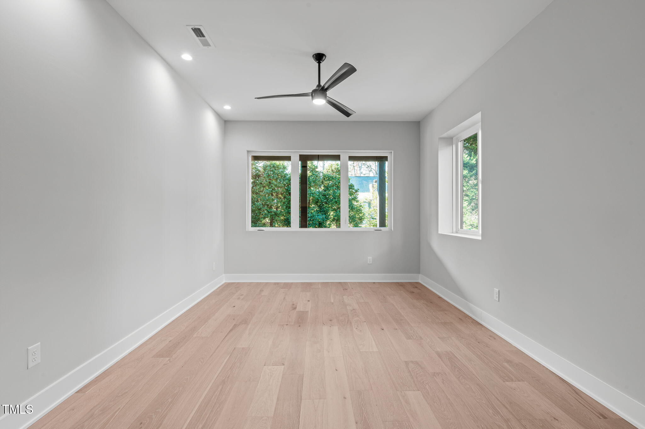 1439 Duplin Road Raleigh, NC 27607 - Photo 51 of 78 wooden floor in an empty room with a window