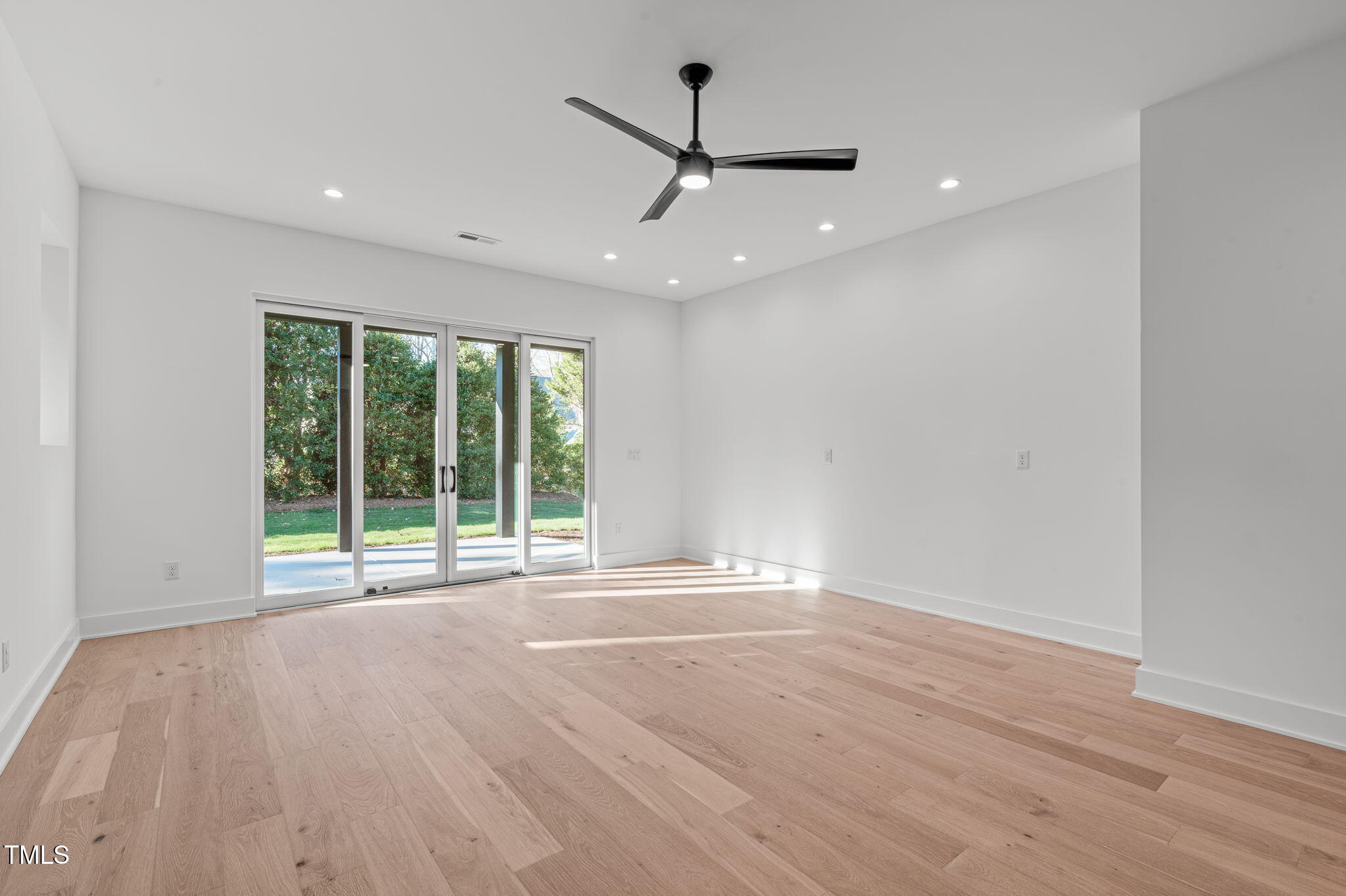 1439 Duplin Road Raleigh, NC 27607 - Photo 54 of 78 a view of an empty room with wooden floor and a window